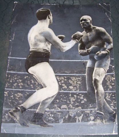 5 items connected with Jack Johnson: , including an original photograph of Johnson fighting in Paris 1913; an early postcard size pic of Johnson; a copy of Boxing July 4 1914 with the cover showing Johnson v Moran fight; a large much ove