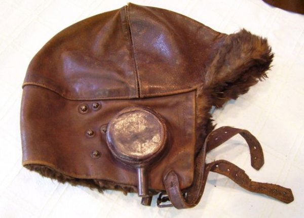 KINGSFORD SMITH'S AIRHELMET & GOGGLES: A leather air-helmet, approx 24 x 25cm when flat, as used by Charles Kingsford Smith in 1928, together with his goggles, as gifted to the original Mascot caretaker, George Burns that year. Helmet has