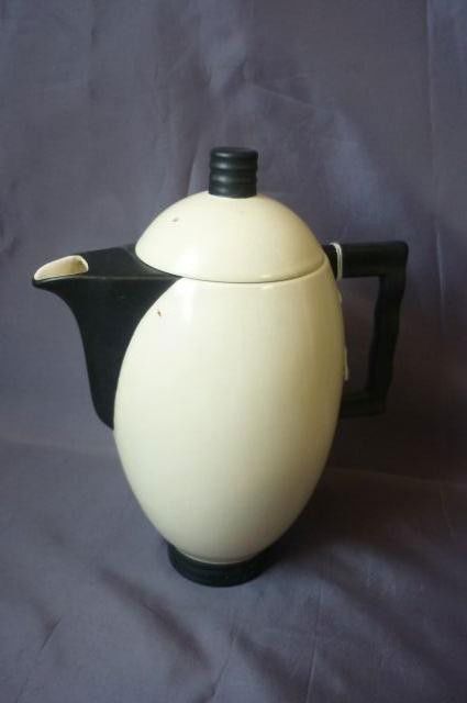 Carlton Ware Teapot,: of ovoid form, in a black ad white glaze, on circular form, h 21cm