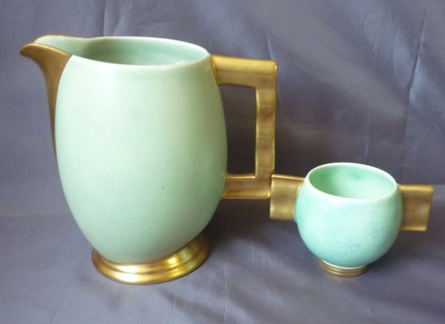 Carlton Ware Jug,: with a gilt spout and handle on a mottled green goung, together with a simlar decorated Carlton Ware squat vase, (2)