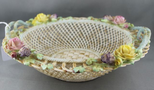 Belleek Two Strand Twin Handled Basket,: of circular form, with woven base and sides, the edge decorated with applied coloured flowers and bud, d 23.5cm