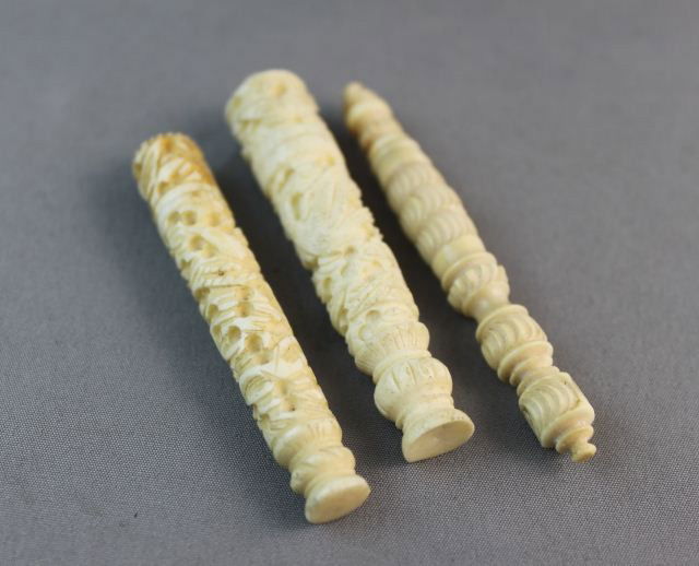 Two 19th Century Chinese Carved Ivory: Needle Cases, c.1860, together with another turned ivory stiletto and case, (3)