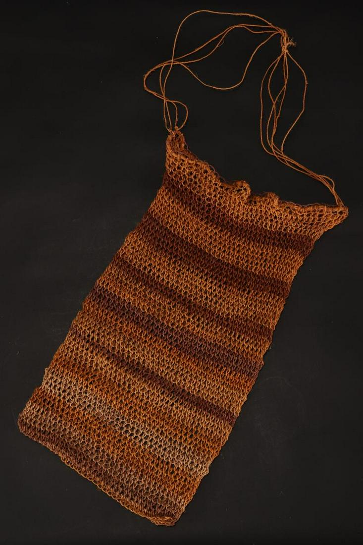 Australian Aboriginal Knotted String Bag,: in natural fibre, of rectangular form, with string strap, with banded decoration in tones of mustard and purple, height 34.5cm