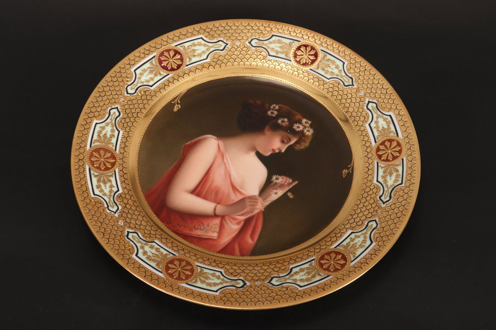 Beautiful Royal Vienna Cabinet Plate,: c.1900, of circular form, finely painted with maiden wearing daisies in her hair an and titled 'Marqueritte,' diameter 24cmd picking the petals off a daisy in her hand, surrounded by heavy gilt border