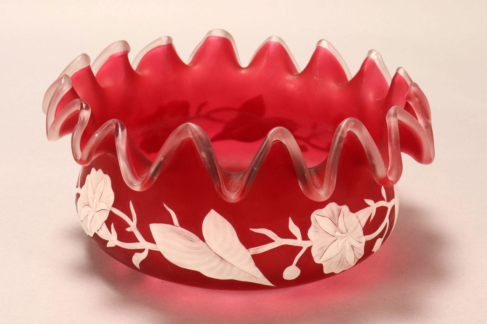 Thomas Webb Cameo Glass Bowl,: with a frilled lip, in ruby glass, decorated with overlay morning glory flowers, height 12cm and diameter 26cm