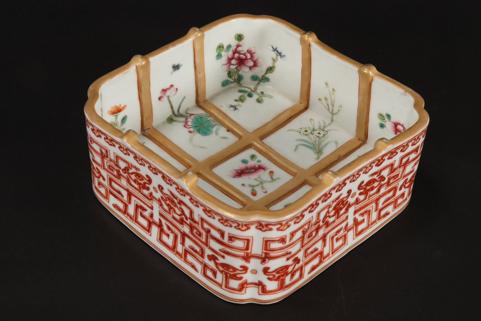 Chinese Porcelain Dish,: of square form, the interior decorated with a raised lattice finish and painted with sprays of flowers, the exterior decorated with taotie motifs, seal mark to base, 5.5cm x 13cm x 13cm
