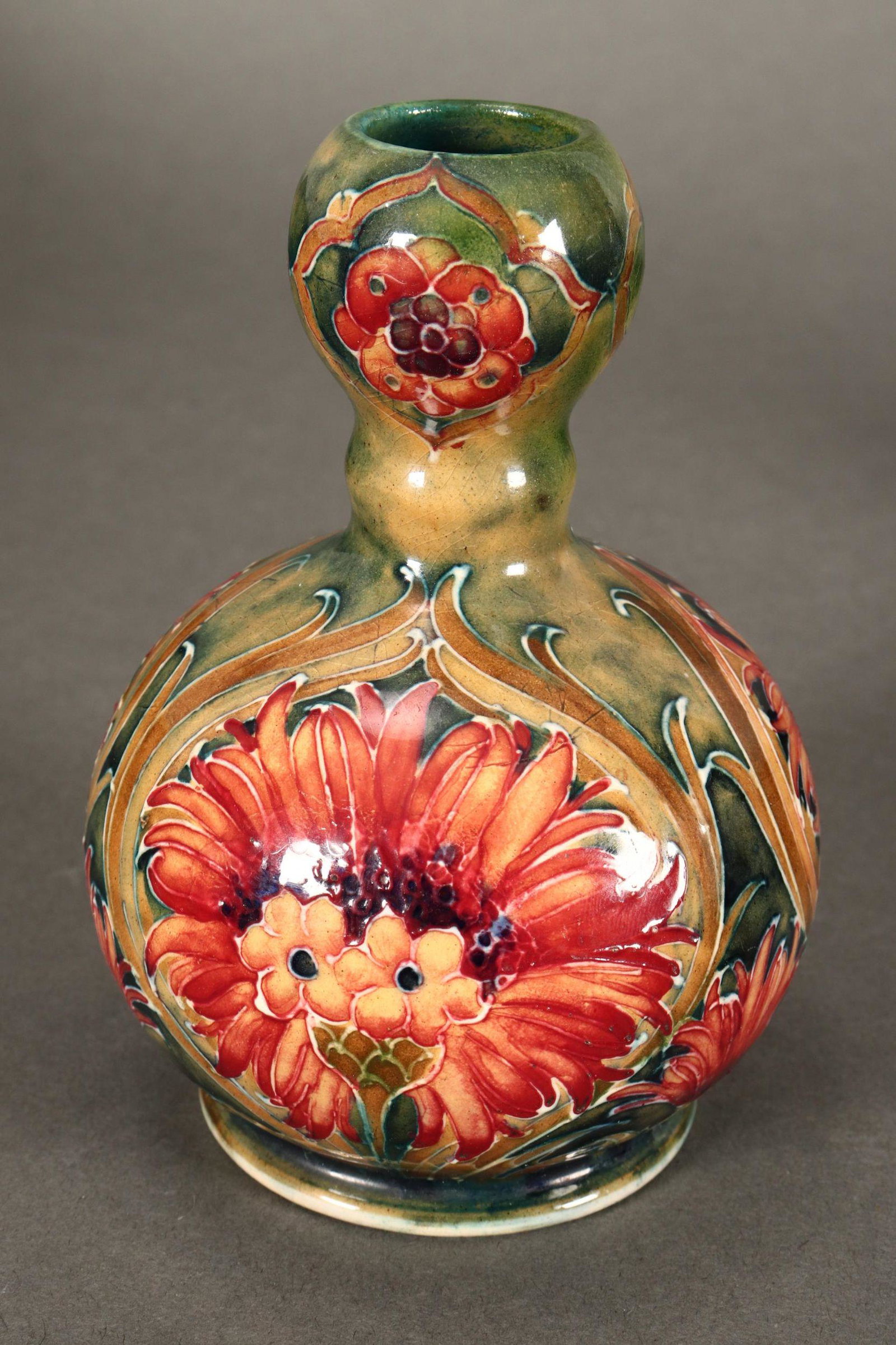 William Moorcroft 'Cornflower' Vase,: c.1912, the body of globular form with a knopped neck, decorated with cornflowers against a mottled green ground, signed to base, impressed '25' mark, height 11.5cm