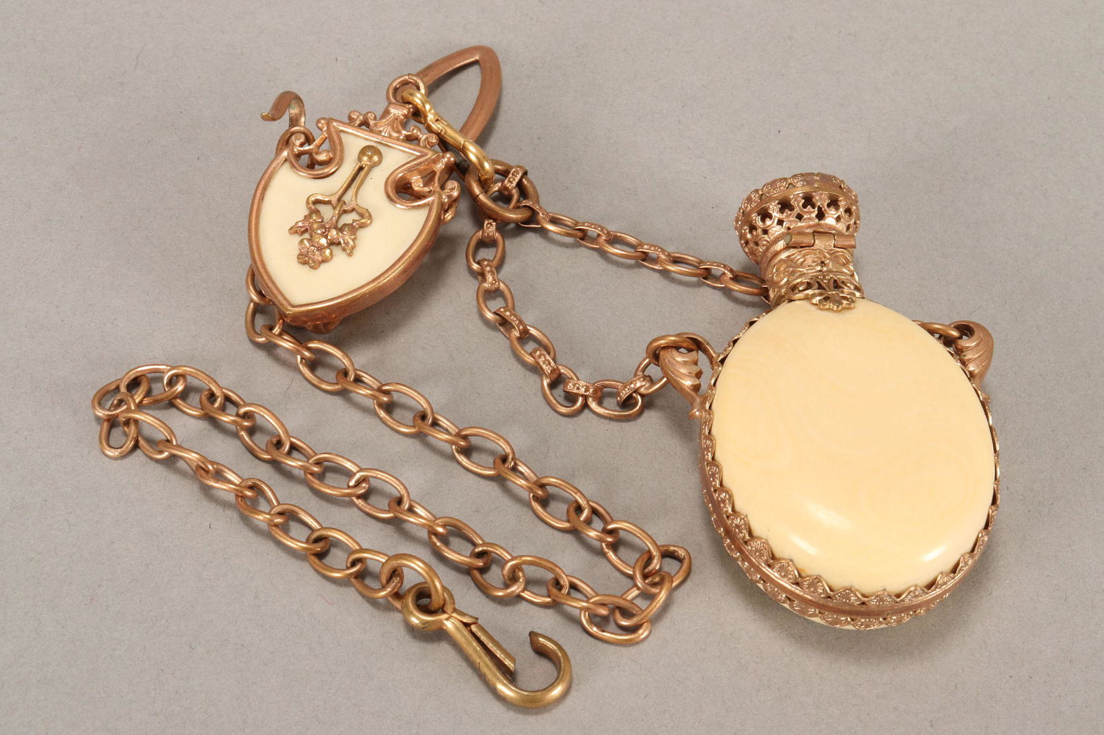 Late 19th/20th Century Gilt Chatelaine,: with perfume bottle and fan chain, the bottle of baluster form, with filigree mountsPublished: Chatelaines: Utility to Glorious Extravagance, 1995, colour plate 115b