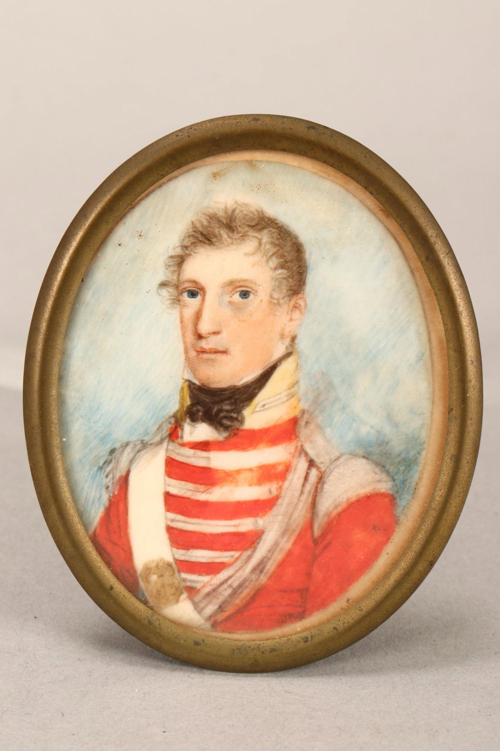 19th Century English Portrait Miniature,: Portrait of Captain James Hay, depicted in three quarter sinister in a red military uniform, inscribed 'Capt. James Hay// Southerland Highlanders// died 1838,' watercolour, of oval form 7cm x 5.5cm, s