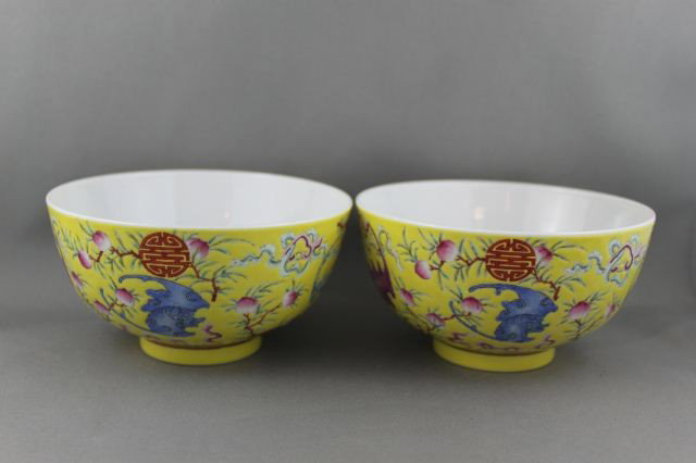 Pair of Chinese Porcelain Bowls,: of tapering form, on a circular foot, incised and decorated with bats, peaches and characters in tones of maroon, blue and green on a yellow ground, six character mark to base