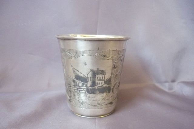 Two 19th Century Russian Silver Beakers,: dated 1865 and 1895, one with niello decoration, the other with engraved leaf and geometric motifs, (2)