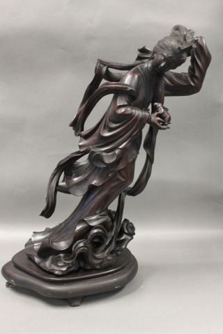 Chinese Carved Figure,: modeled in the form a female immortal, dressed in flowing robes, her single hand grasping a rabbit, all resting on a cloud scroll base. height 50cm