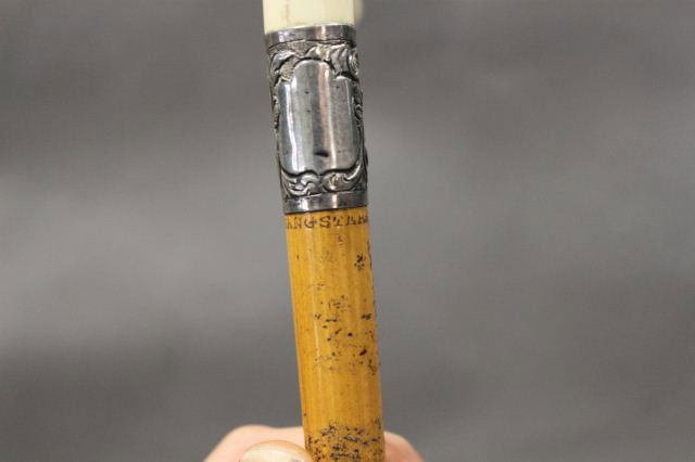 Late 19th Century Ivory Handled Swagger Stick,: c 1900, for Sangster's , of tapered form with an applied silvered collar Length 48cm