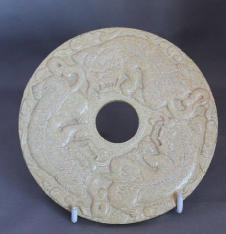 Chinese Carved Bi Disc,: of circular form, in cream tones carved with buddhist lions, d 14cm