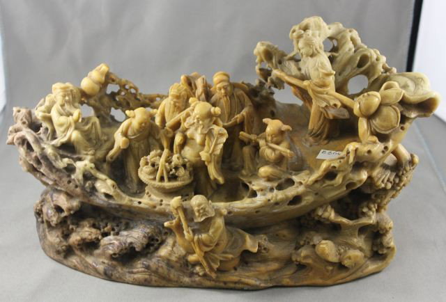 Good Chinese Soapstone Figure,: modeled in the form of a rustic vessel being manned by immortals, all resting on a rocky outcrop, l 29cm