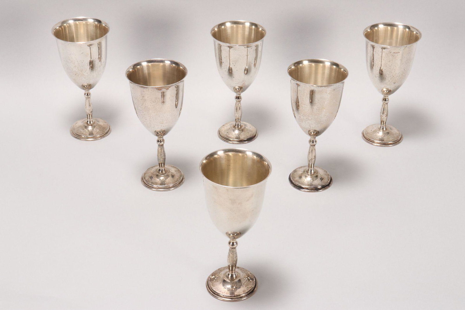 Six Mexican Sterling Silver Goblets,: marked 925, with tapered bowls above a knopped stem, on a stepped circular foot, total weight 997gm, height 15.5cm (6)