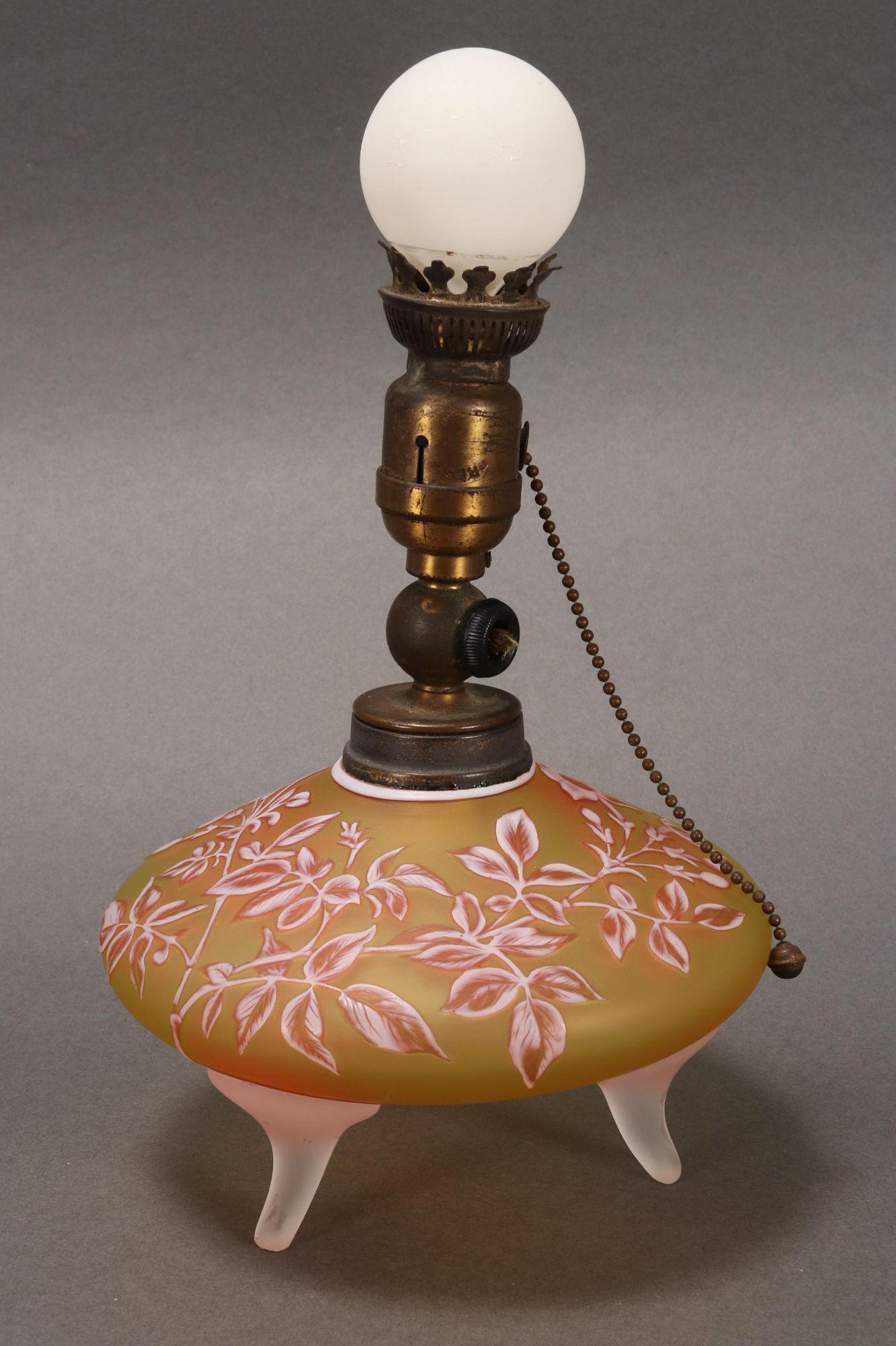 Thomas Webb Cameo Glass Lamp,: of petit form, decorated with flowers and foliage, in tones of yellow, orange and white, raised on three frosted glass feet, height 21cm