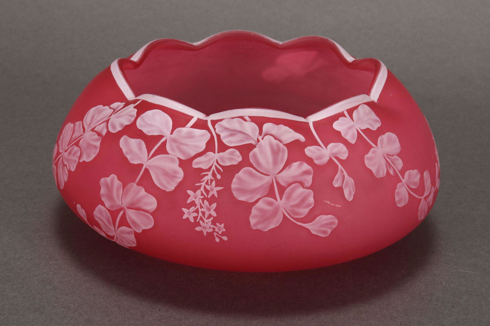 Thomas Webb Cameo Glass Bowl,: of squat form with a pinched rim, decorated with trailing vines and butterfly, in tones of pink and white, incised marks to base, height 7.5cm and diameter 15cm