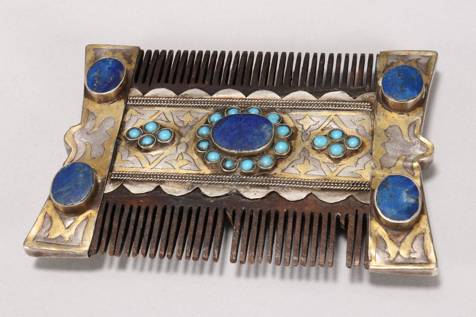 Middle Eastern Parcel Gilded Comb,: accented with oval lapis stones and turquoise coloured stones, a/f, 10cm x 7cm