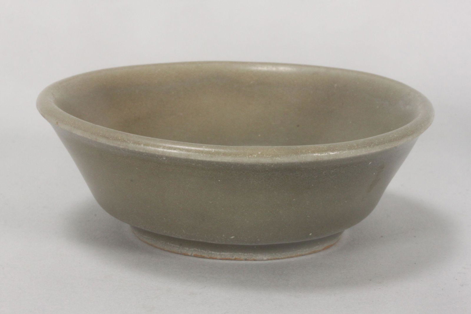 Chinese Longquan Celadon Brush Washer,: Yuan Dynasty, of shallow slightly flared form, in pale green tones, height 3cm and diameter 9cm, with Art Gallery of New South Wales inspection report.