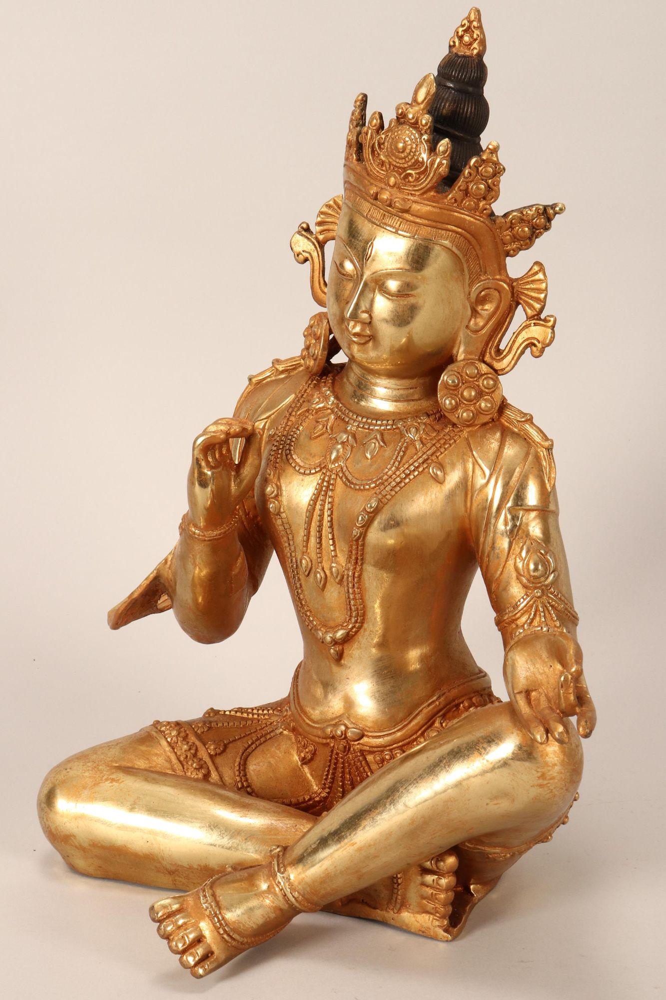 Bronze Sino-Tibetan Bronze Buddha,: depicted seated with legs crossed, with elaborate head dress, with left hand resting on knee in Prithri mudra, with downcast serene expression, height 37.5cm