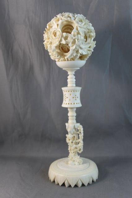 Chinese Carved Ivory Puzzle Ball and Stand,: carved with outer floral exterior, with at least ten interior balls, the whole on a carved and pierced stand, slight a/f to stand, h 22cm