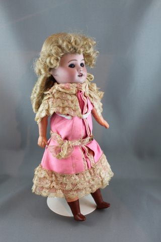 French SFBJ 60 Paris: 10.5in/27cm marked 8/0 composition body with straight legs, painted shoes, old replaced dress and wig, blue glass set eyes, hairline on bisque forehead