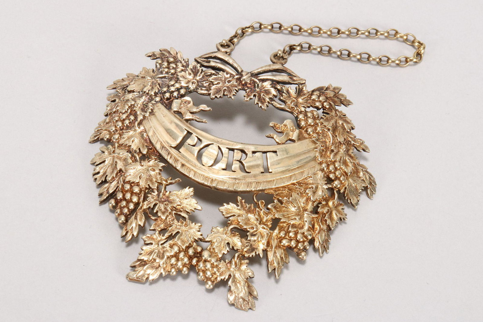 Large George III Gilt Sterling Silver Wine Label,: hallmarked London, 1806, D.S/ B.S (Digby Scott & Benjamin Smith II), of wreath design with finely cast depictions of vine leaves and grapes encircling a central banner with pierced 'Port' label, total