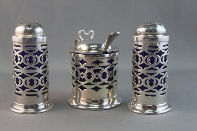 Edwardian Sterling Silver Four Piece Cruet Set,: hallmarked, Birmingham, 1904, of cylindrical form, with pierced boarders and blue liners, (4)
