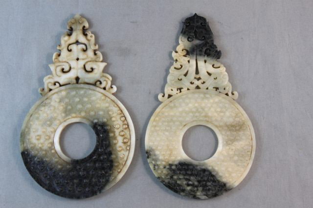 Two Chinese Jade Bi Discs,: of circular form, with carved and pierced finials, h 15cm (2)