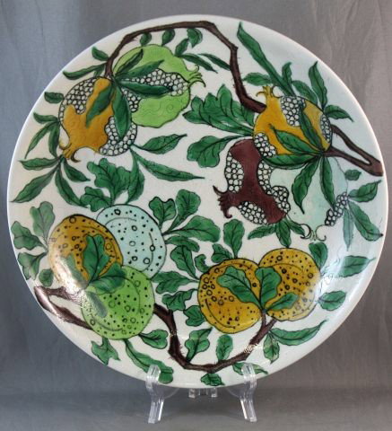 Chinese Porcelain Plate,: of circular form, decorated with branches of fruit, in tones of green, yellow, blue and brown, with a incised dragon motif below, six character mark and double circle to base, d 24.5cm