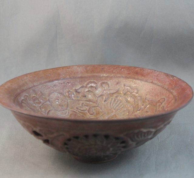 Chinese Porcelain Bowl,: in a brown/red glaze decorated with a raised figure of a boy, d 15cm
