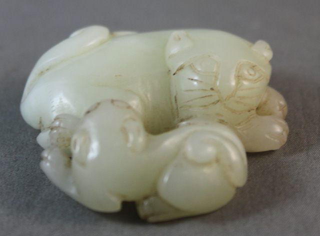 Chinese White Jade Figure of a Kylin: modelled in recumbent form with a single cub at its feet length 5cm