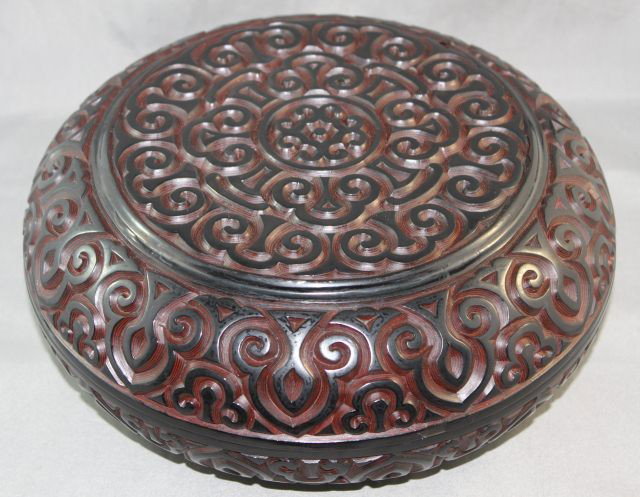 Large Chinese Black Cinnabar Storage Box,: modelled in circular form, and decorated throughout with geometric scrolls, d 25cm