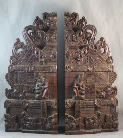 Pair of Carved Javanese Architectural Book Ends,: each modelled in the form of temple, profusely carved with clouds scrolls, figures and linear decoration, h 35cm
