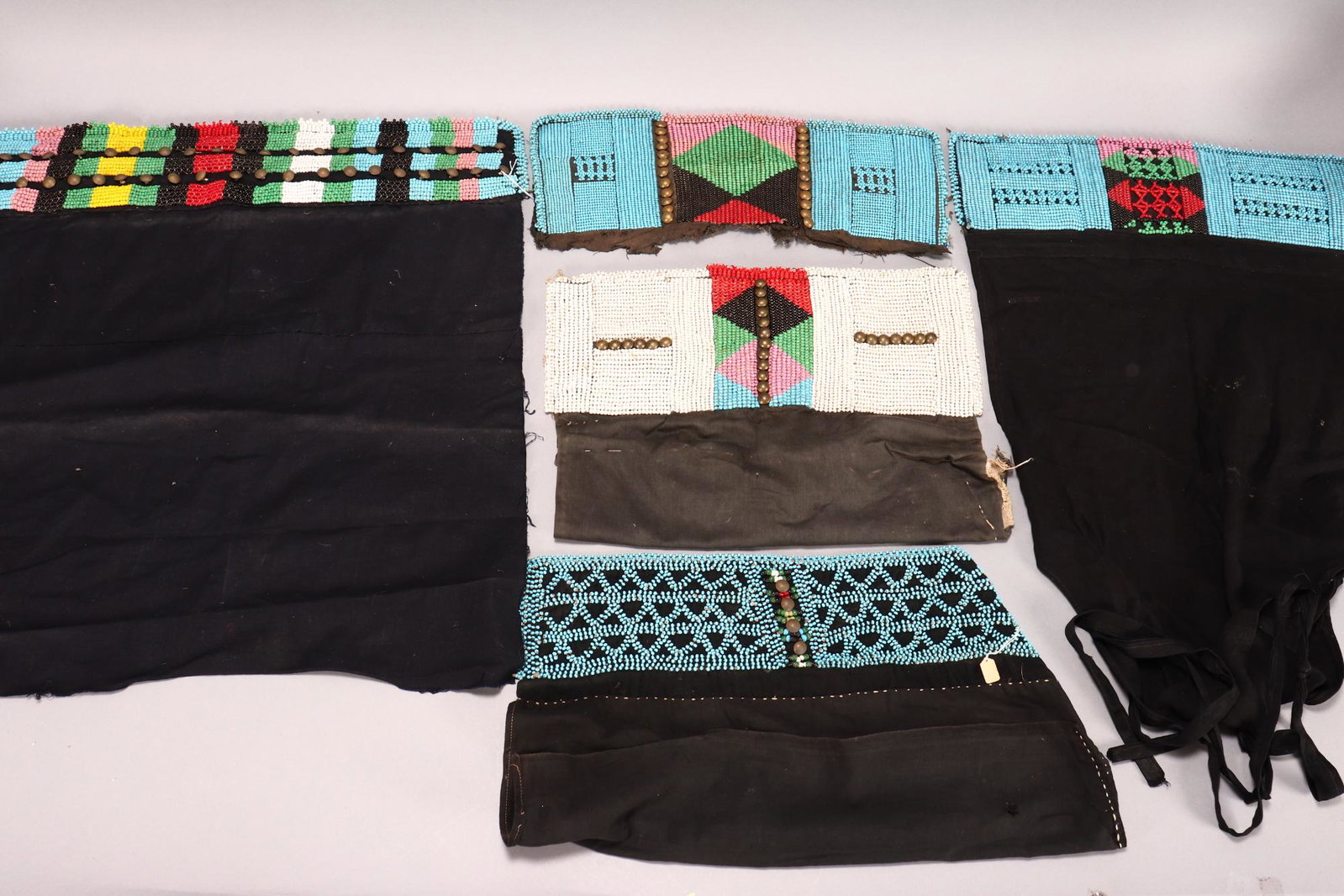 Three Zulu Beaded Waistband Aprons, South Africa,: together with a Zulu beaded waistband and a Zulu style apron (5)