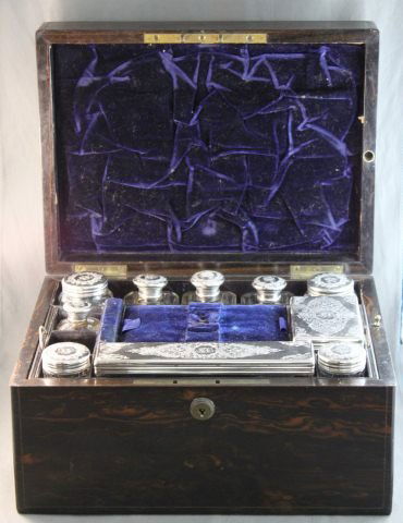 Beautiful Victorian Coramandal Toilet Box and: Cover, of rectangular form, with inset circular monogramed panel, opening to reveal toiletry boxes with sterling silver covers, hallmarked, London, 1864, with secret drawer, 30cm x 17cm