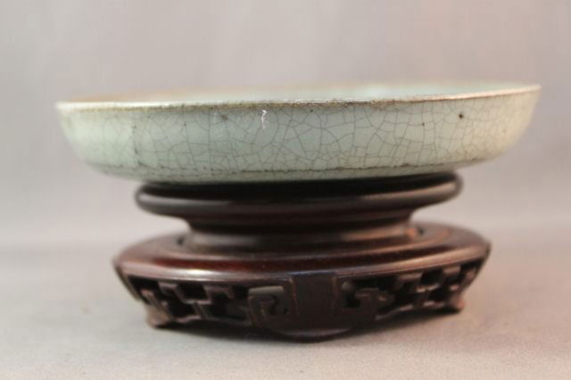 Chinese Earthenware Shallow Dish,: with russet highlights on a hardwood stand d 12.5cm