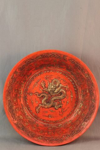 Chinese Ceramic Bowl,: of circular form, in faux cinnabar, decorated with a raised gilt dragon and frieze surrounds, four character mark to base, d 16cm