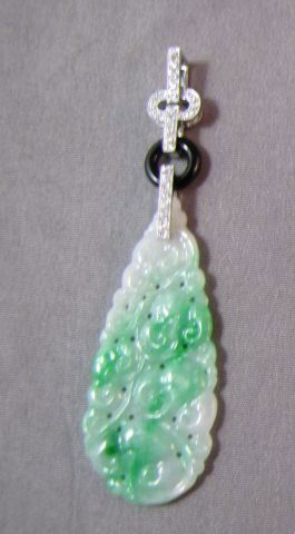 18ct Gold, Jade (type A) and Diamond Pendant,: the jade carved in the form of scrolling foliage, suspended from 22diamonds totaling 0.22ct,with certificates