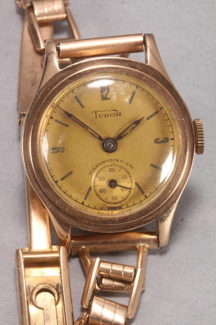1940's Tudor 9ct Gold Wristwatch,: stamped 9ct to inner cover and band, manual wind, with circular brushed gilt dial, marked to dial 'Tudor/Rolex Watch Co.', set in a 9ct gold case with presentation engraving to rear, case diameter 28m