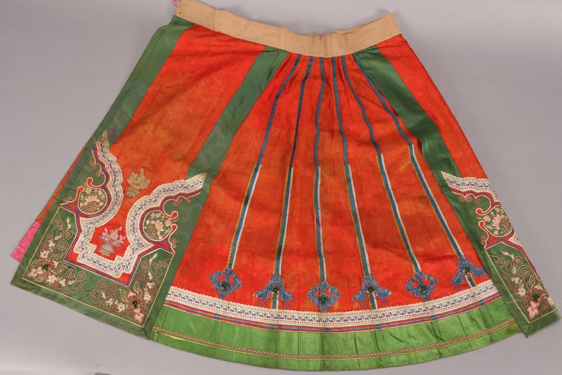 Chinese Late Qing Dynasty Summer Skirt,: in burnt orange damask silk, with green silk trim embroidered with stylised butterflies and flowers, with applied vases of flowers in tones of pink, green and purple and applied blue ruyi heads set wi