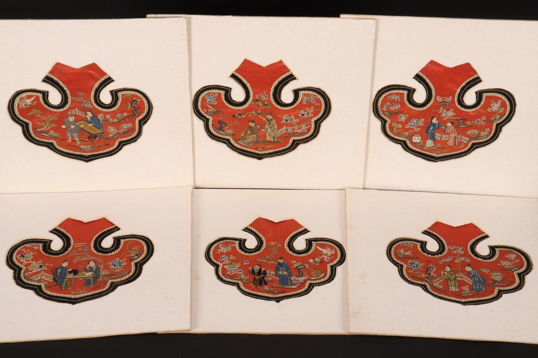 Set of Six Chinese Embroidered Yunjian,: of ruyi form, decorated with images of children in a garden, in bright tones on a red to orange ground (6)