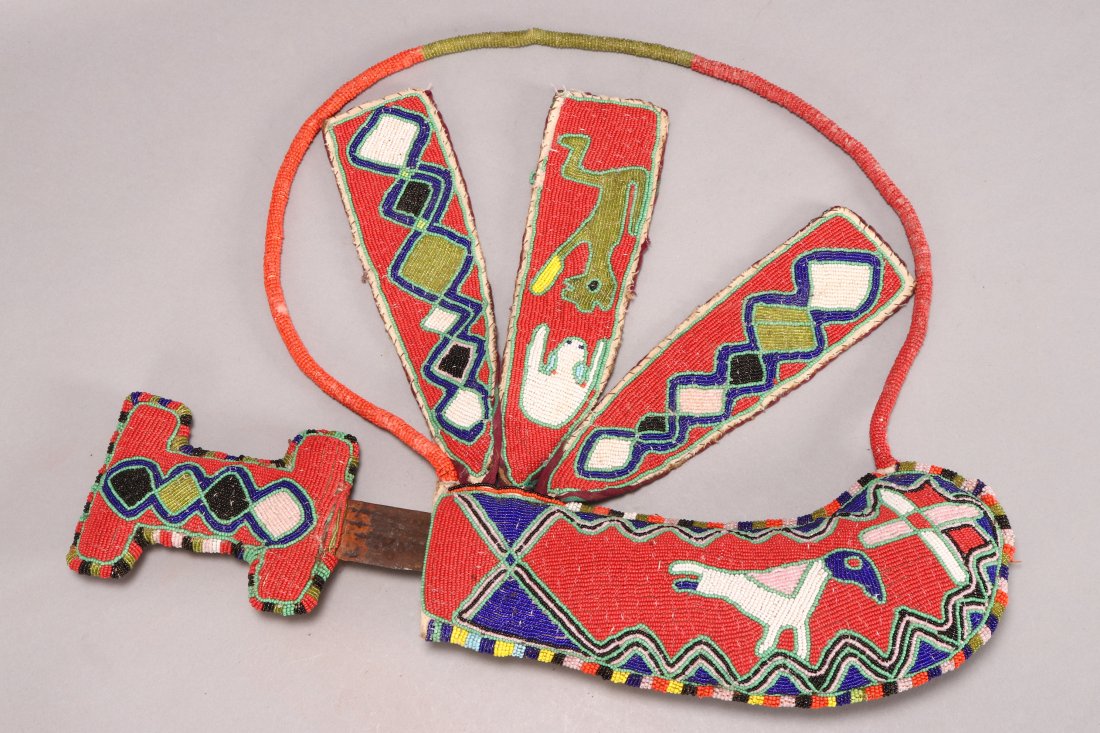 Udamalore Ceremonial Sword and Sheath,: with a rectangular shaped beadwork handle, set with rectangular blade, set within beadwork sheath displaying birds and decorative patterns, length 52cm