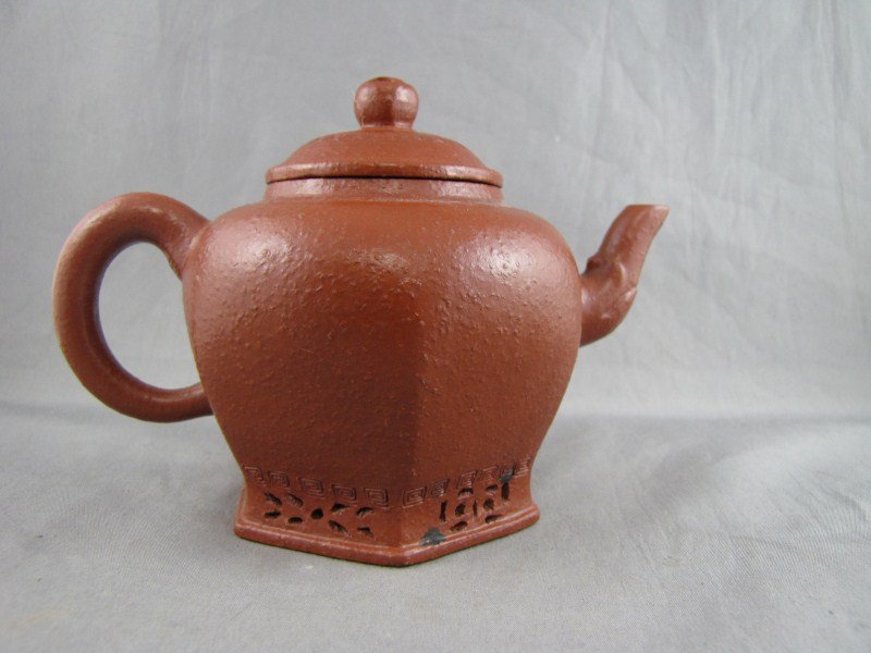 Chinese Yixing Teapot,: of facetted baluster form, incised character marks to base, h 11cm Provenance: Young Chi Man Estate
