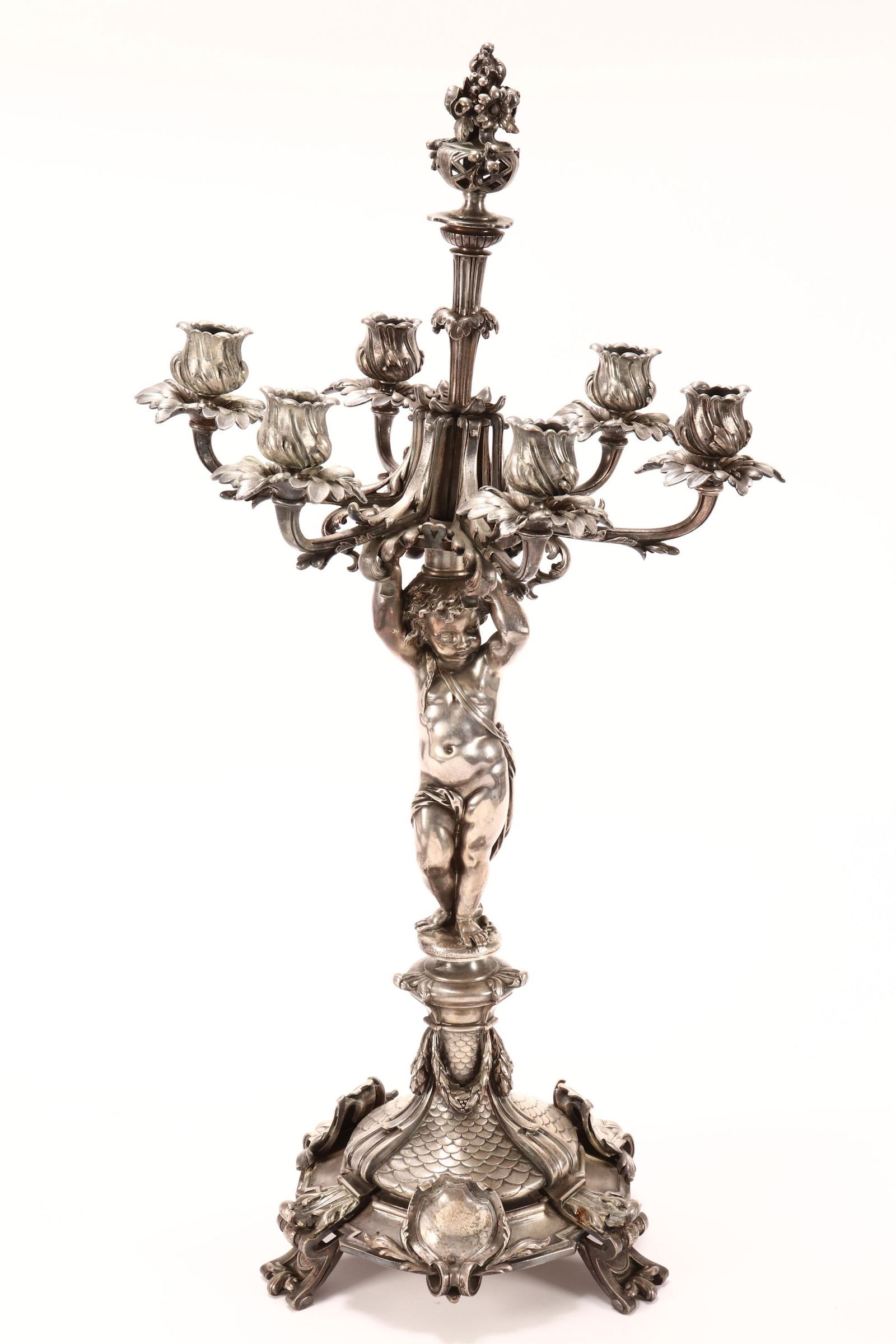 Magnificent Christofle Silvered Bronze Candelabra,: set with six branched sconces and central floral finial, supported by a robed putto, above an ornate base, accented with swags, medallions, acanthus and scale motifs, raised on four scrolled feet, mak