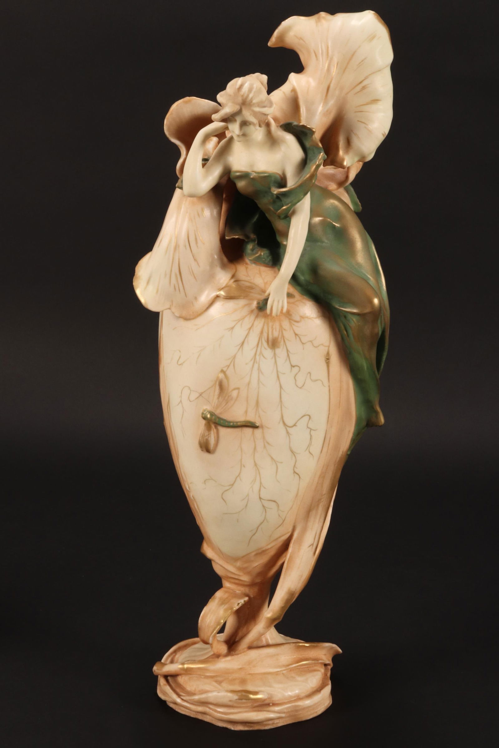 Late 19th/20th Century Imperial Amphora Art Nouveau Vase,: of organic form, depicting a maiden seated on an iris, surrounded by dragonflies, in rich tones of green and gilt on a blush ground, impressed factory marks to base, height 44cm