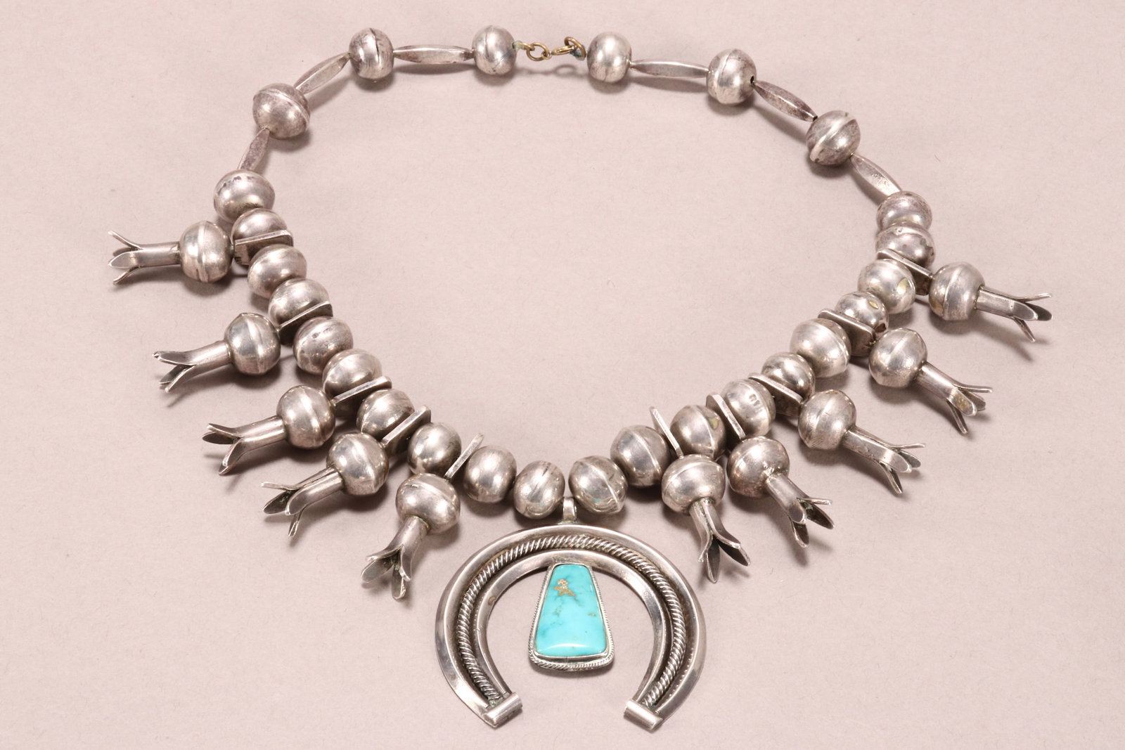 Navajo Silver & Turquoise Squash Blossom Necklace,: central horseshoe pendant set with turquoise stone, with ten blossoms, unmarked, drop length 30cm