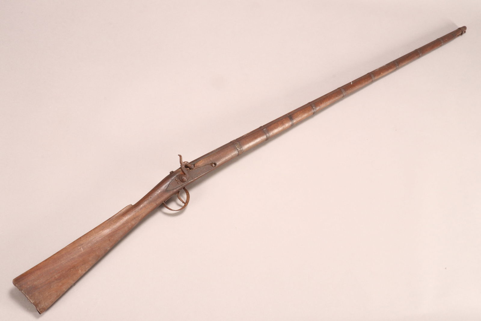 19th Century Dane Gun Musket,: with narrow stock and caned barrel with strip mounts, length 153cm Note: manufactured in Denmark for export to the West African market. These were carried by the Dahomean Army and by Armies in Nigeria