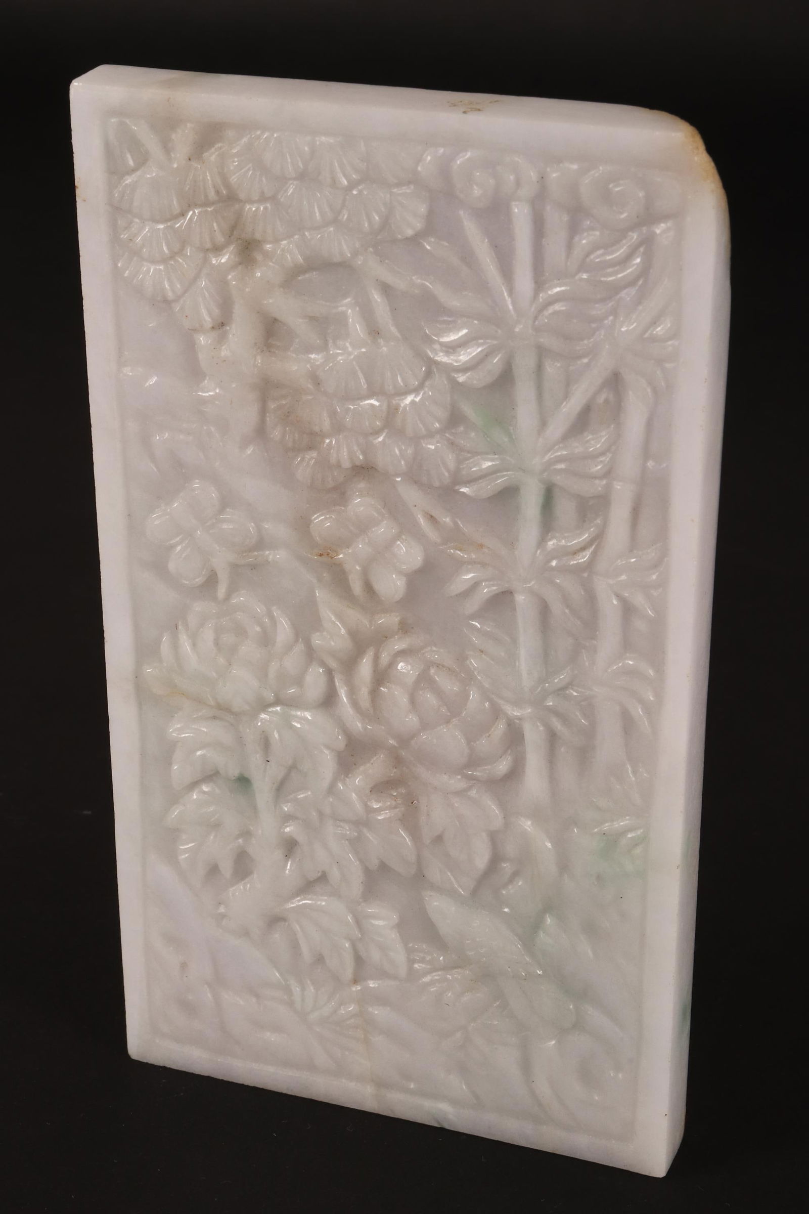 Chinese Carved Jadeite Panel,: of rectangular form, carved with bamboo, birds and chrysanthemum, in tones of white, with green accents, 13.5cm x 7.5cm